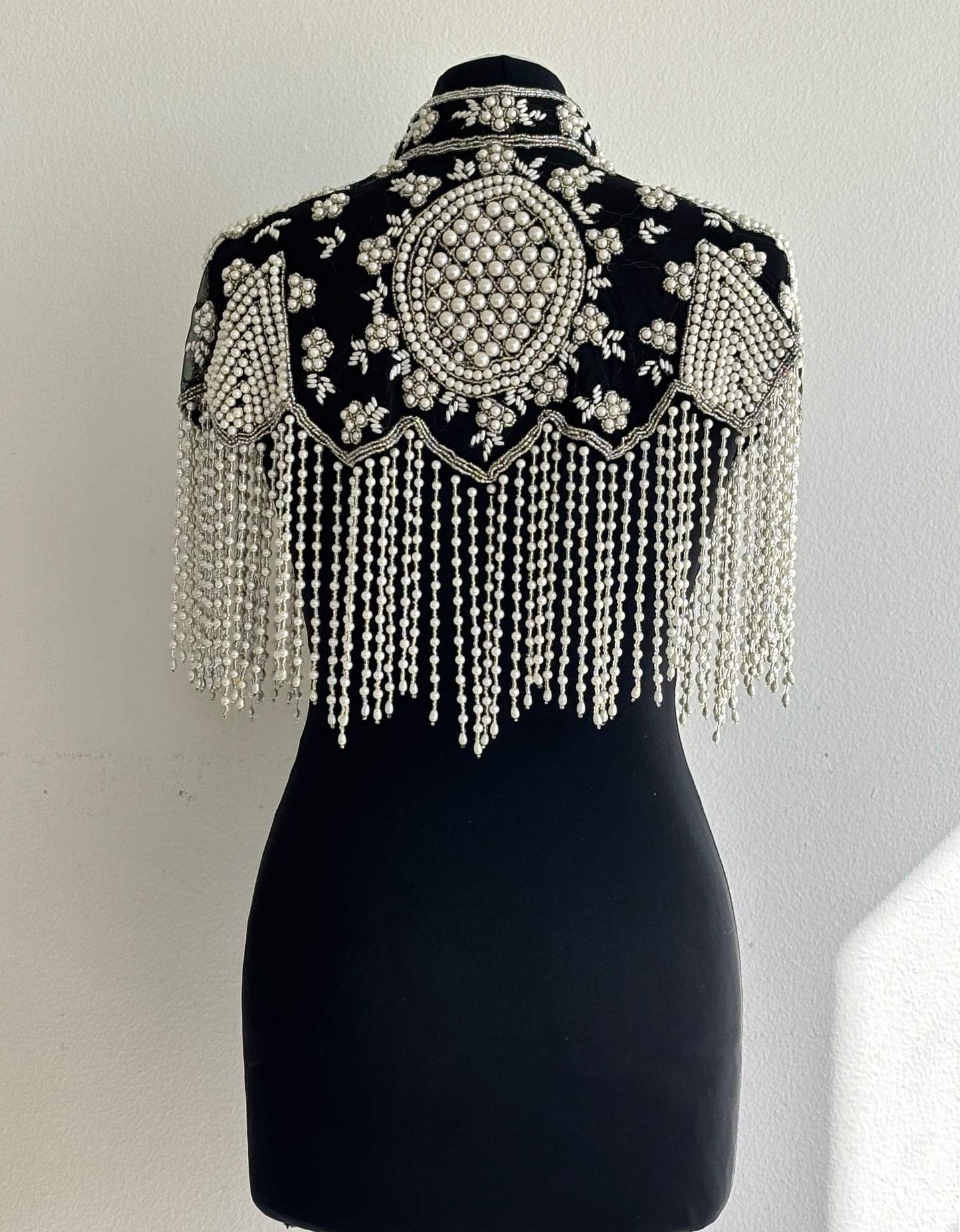 AVASA Black Pearl Beaded Fringe Capelet back view with pearl fringe and black base