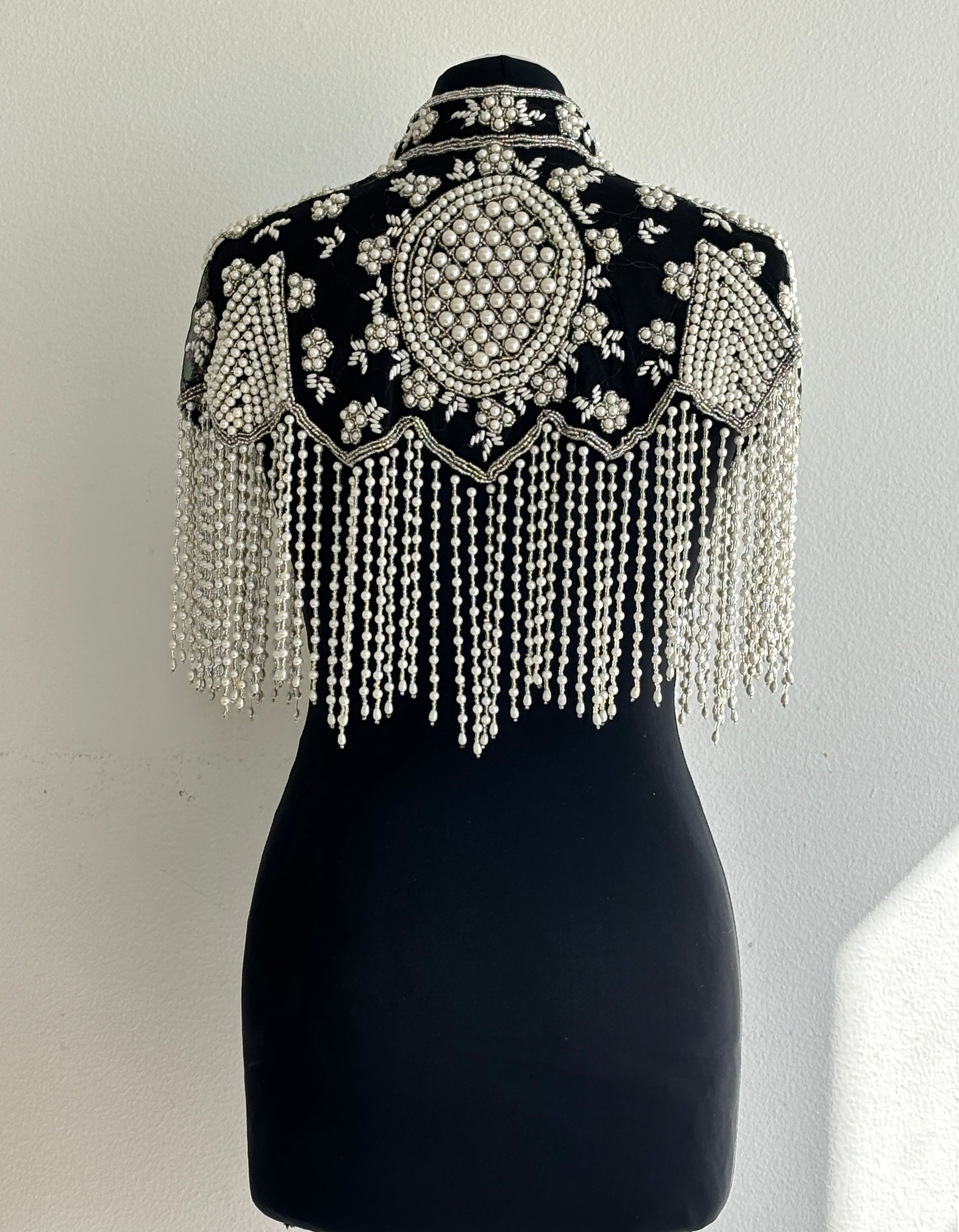 AVASA Black Pearl Beaded Fringe Capelet back view with pearl fringe and black base