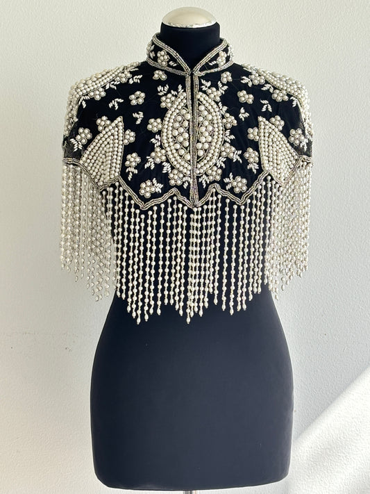 AVASA Black Pearl Beaded Fringe Capelet front view on black fabric base